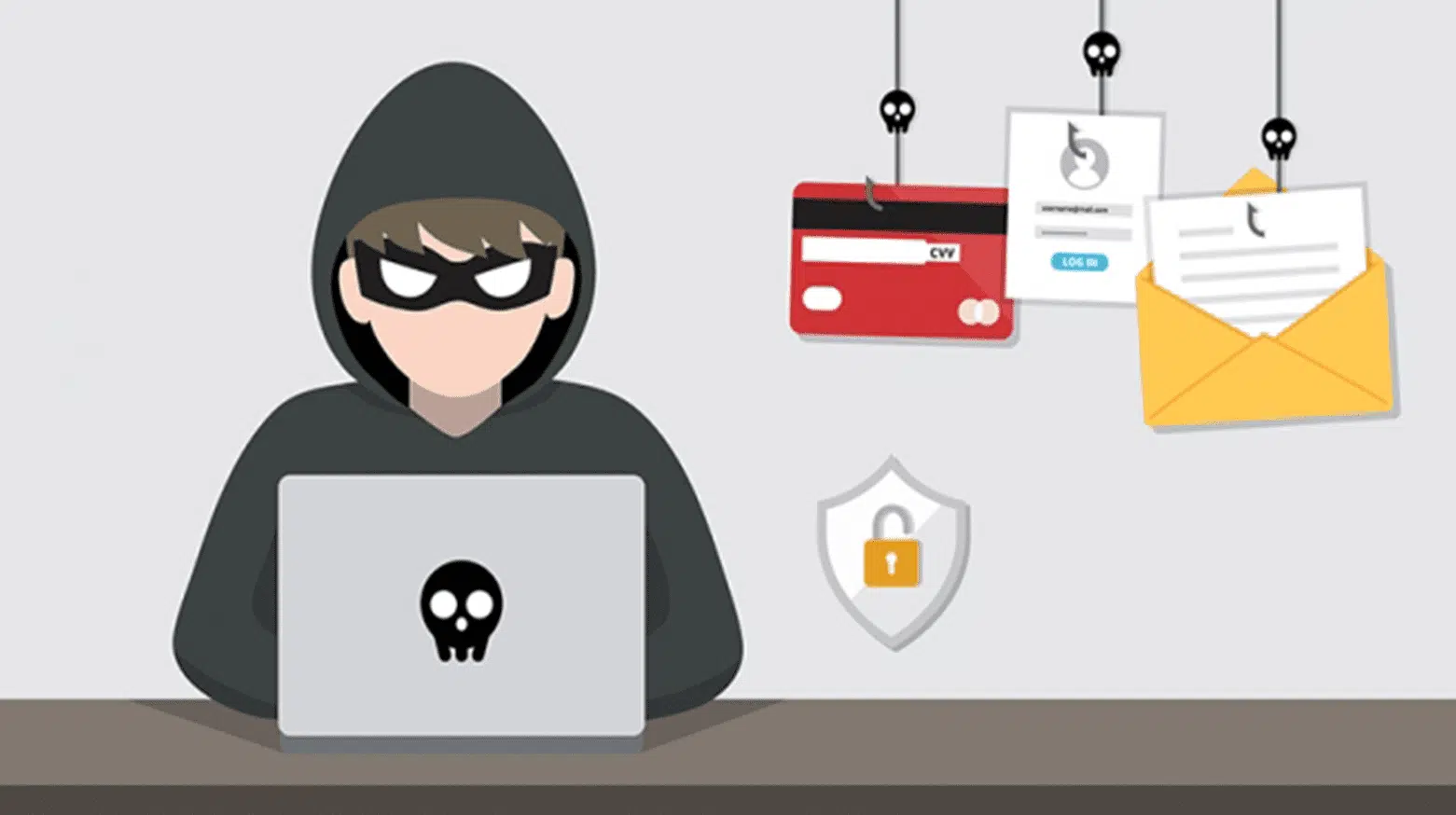 Person in hoodie working on laptop at desk