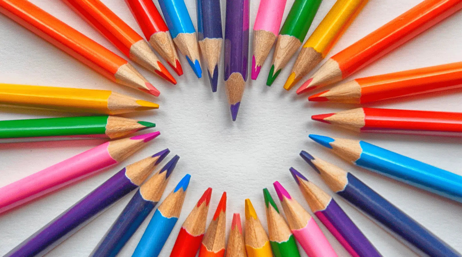 Colorful pencils arranged in a heart shape