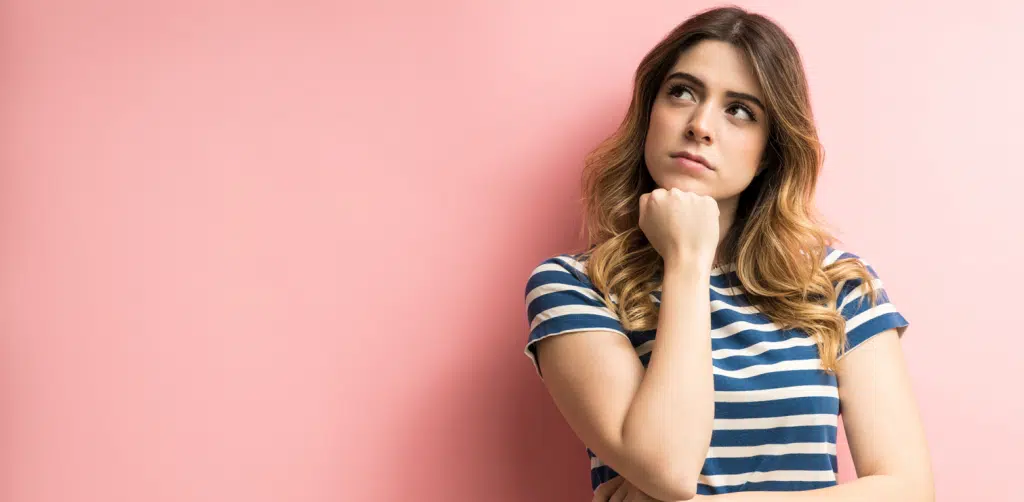 Girl Thinking on a pink background